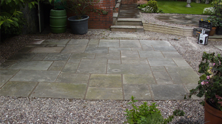 Picture of a finished patio with tools in the corner